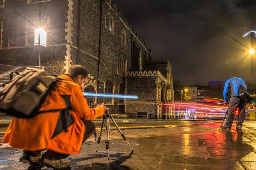 Photographers set up for light trails in night cityscape workshop